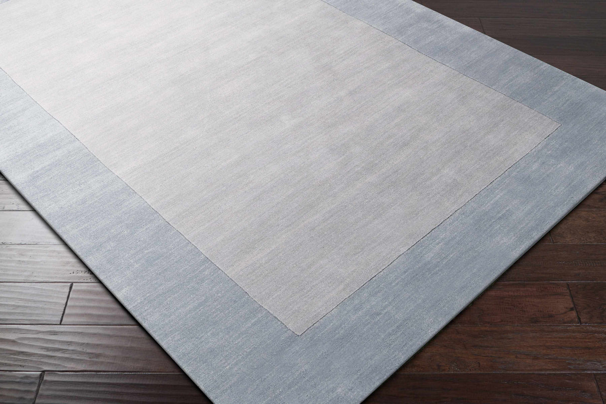 Arkabutla Solid Blue Bordered Wool Rug