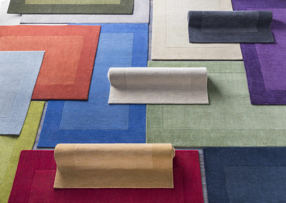 Arkabutla Solid Blue Bordered Wool Rug