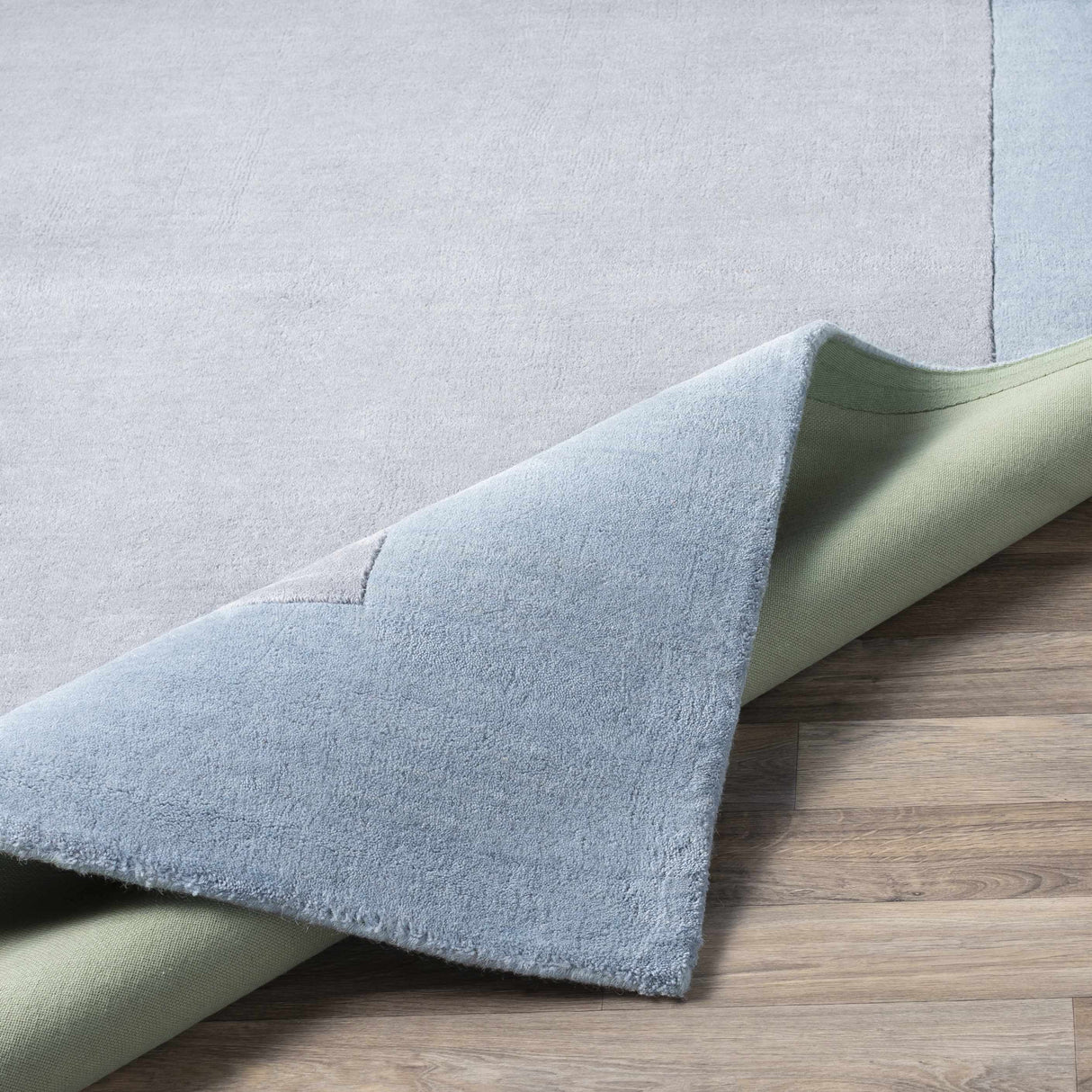 Arkabutla Solid Blue Bordered Wool Rug