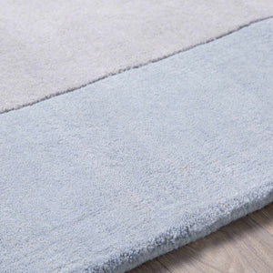 Arkabutla Solid Blue Bordered Wool Rug